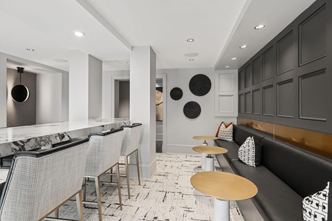A modern restaurant with black and white decor and marble countertops.