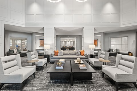 A modern living room with a black coffee table and grey sofas.