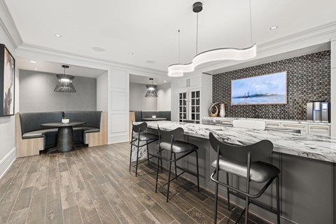 A modern kitchen with a bar area and seating.