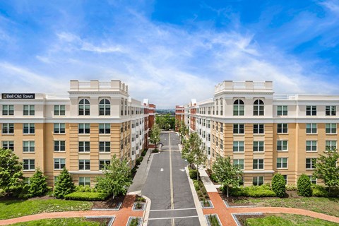 A street view of a residential area with apartment buildings on either side.