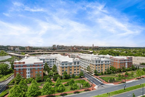 A large building complex with a green lawn in front.