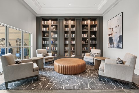 A living room with a large bookshelf filled with books.