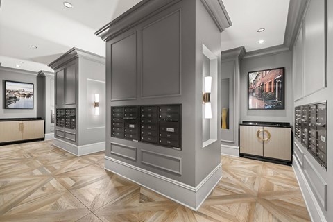 A kitchen with dark cabinets and a wooden floor.
