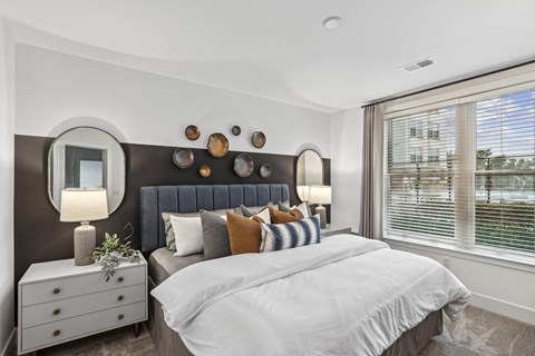 a bedroom with a large bed and a large window