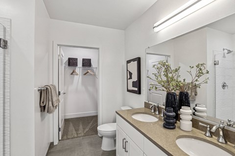 a bathroom with two sinks and a shower and a toilet