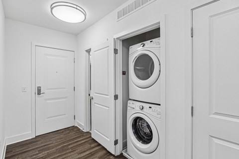 a white laundry room with a washer and dryer