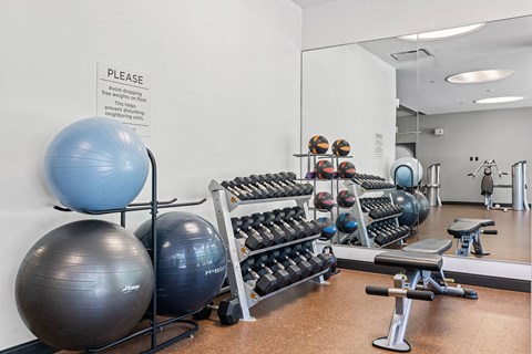 A gym with a sign that says "PLEASE" on the wall.