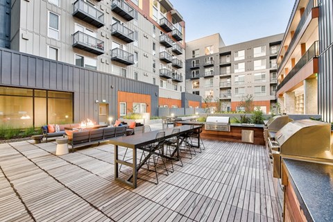 an outdoor patio with a table and chairs in an apartment building