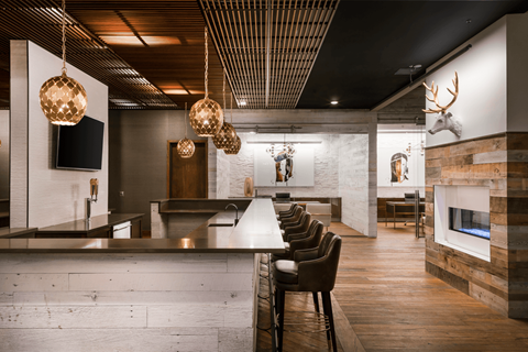 A modern dining room with a long table and chairs.