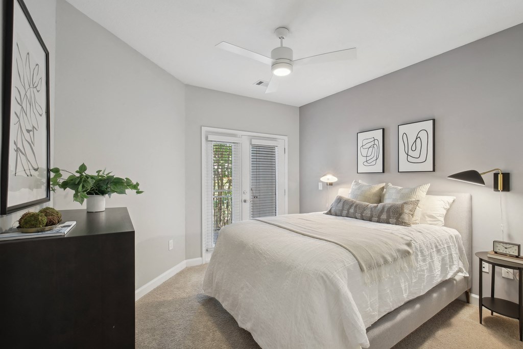 a bedroom with a large bed and a window