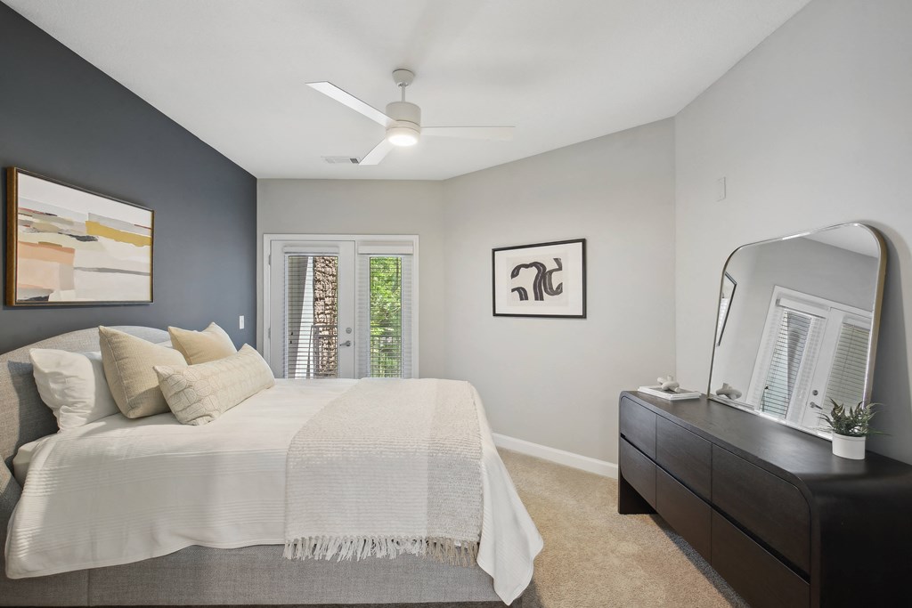 an open bedroom with a large bed and a dresser