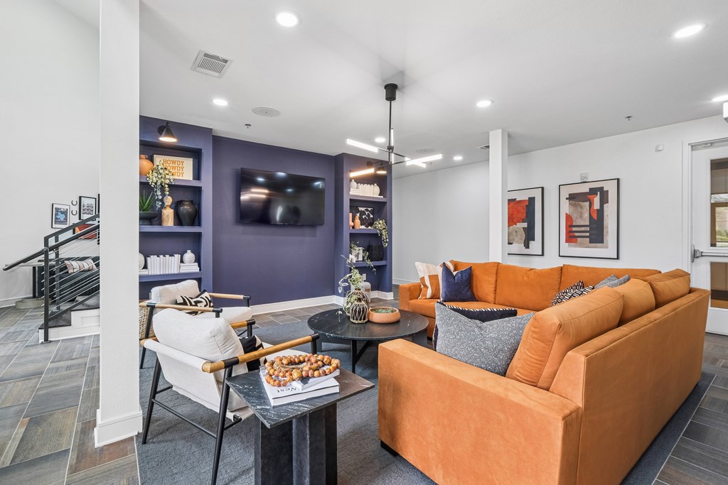 A living room with a purple wall and a white couch.