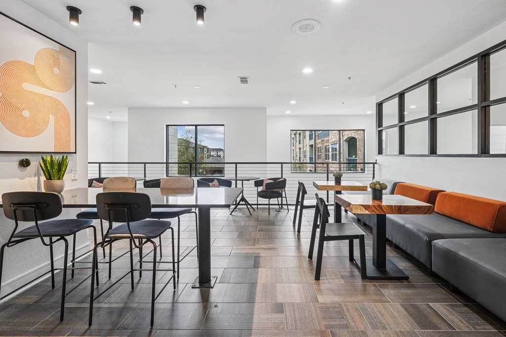 A modern dining area with black chairs and tables.