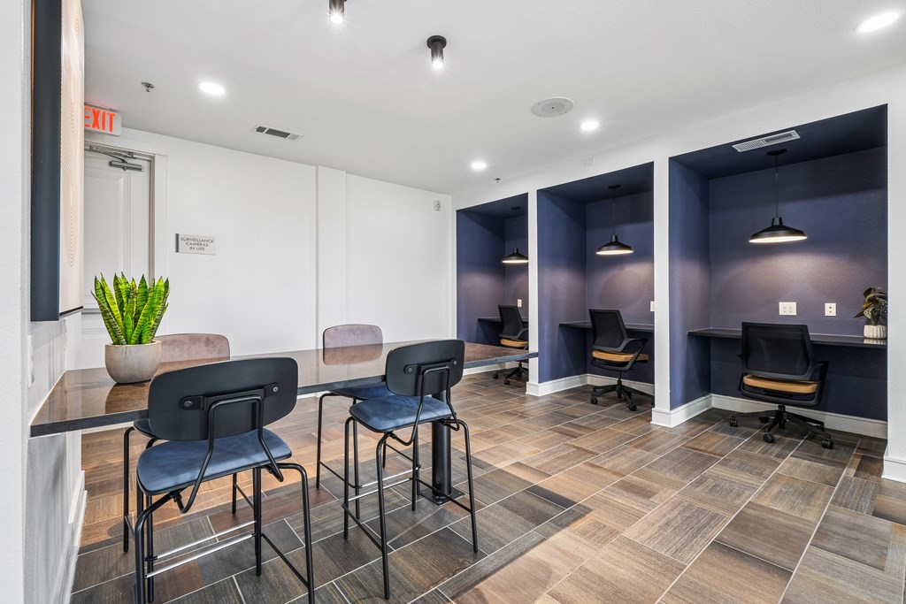 A conference room with a long table and chairs.