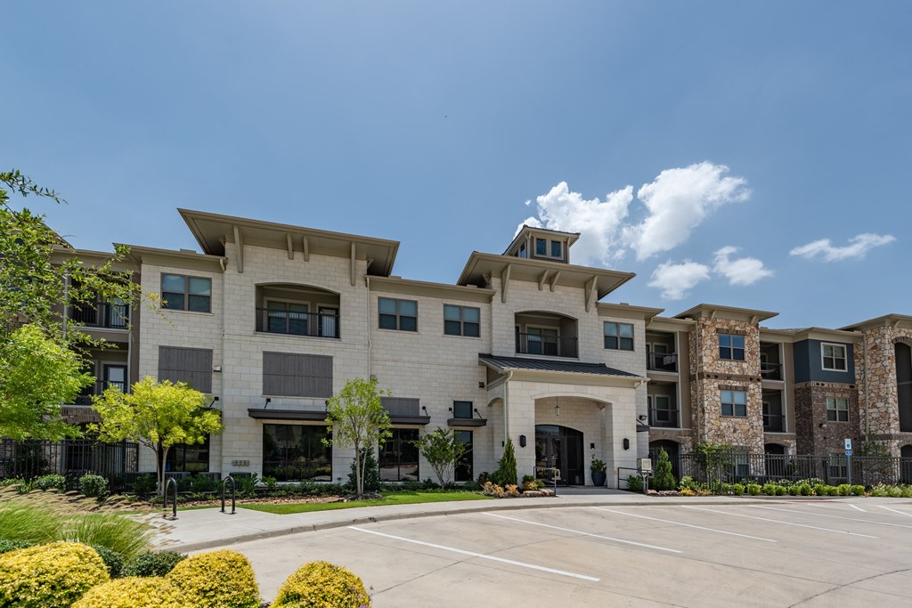 a large building with a parking lot in front of it