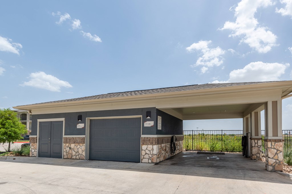 a garage with two doors and a stone wall