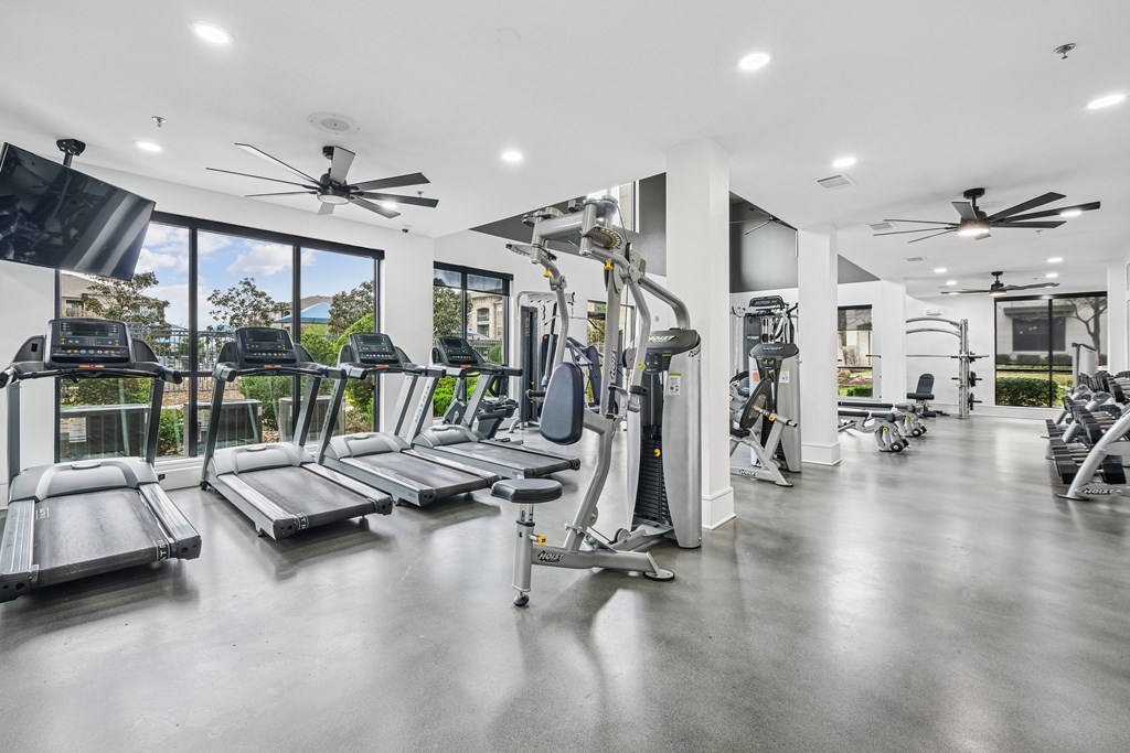 A spacious gym with treadmills, elliptical machines, and other exercise equipment.