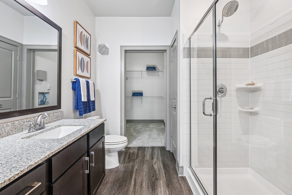 A bathroom with a toilet, sink, and shower.