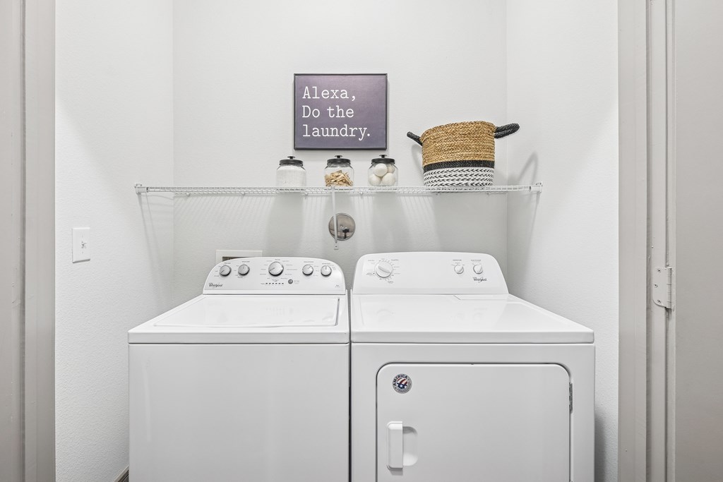 A laundry sign is on the wall above a washer and dryer.