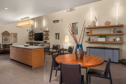A modern dining room with a wooden table and chairs.