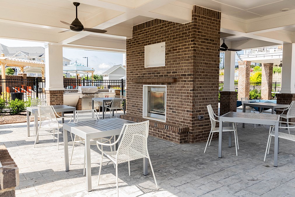 exterior poolside seating with firepit and grills