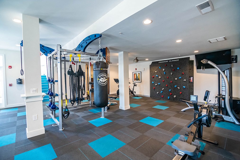 interior clubhouse fitness center with rock climbing wall