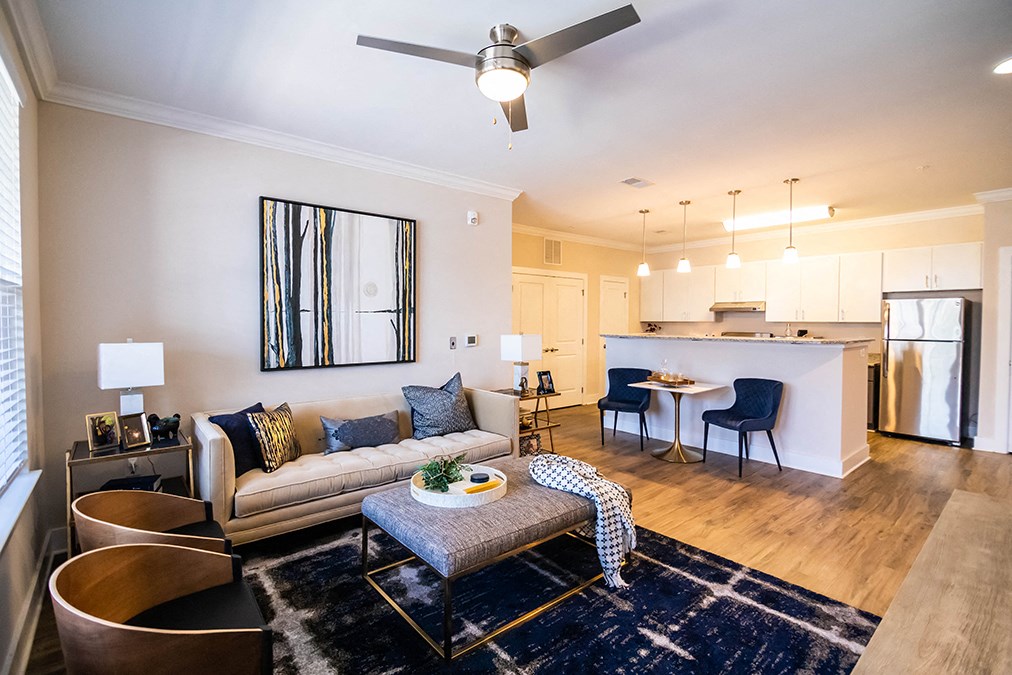 Model Interior Living Room with couch and chairs overlooking kitchen bar island