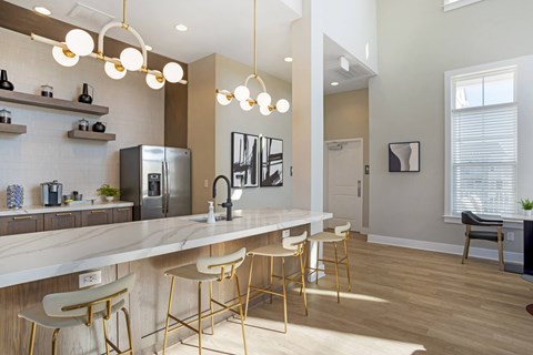 an open kitchen with a large marble counter top and bar stools