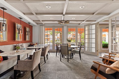 a dining room with tables and chairs and windows