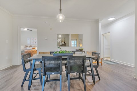 A dining room with a table and chairs.
