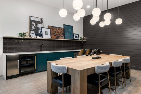 A modern kitchen with a wooden table and chairs.