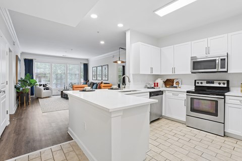 A modern kitchen with white cabinets and a large island.