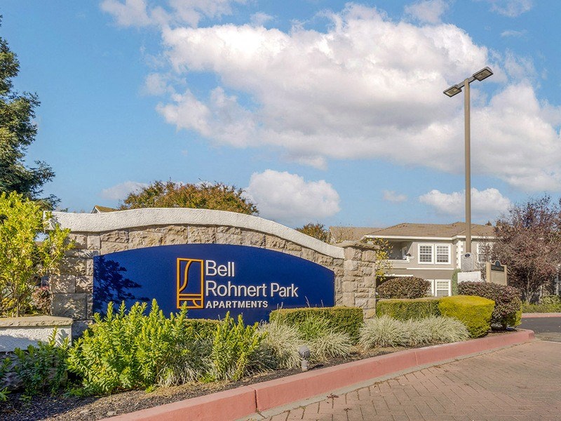 a sign apartments in front of a building
