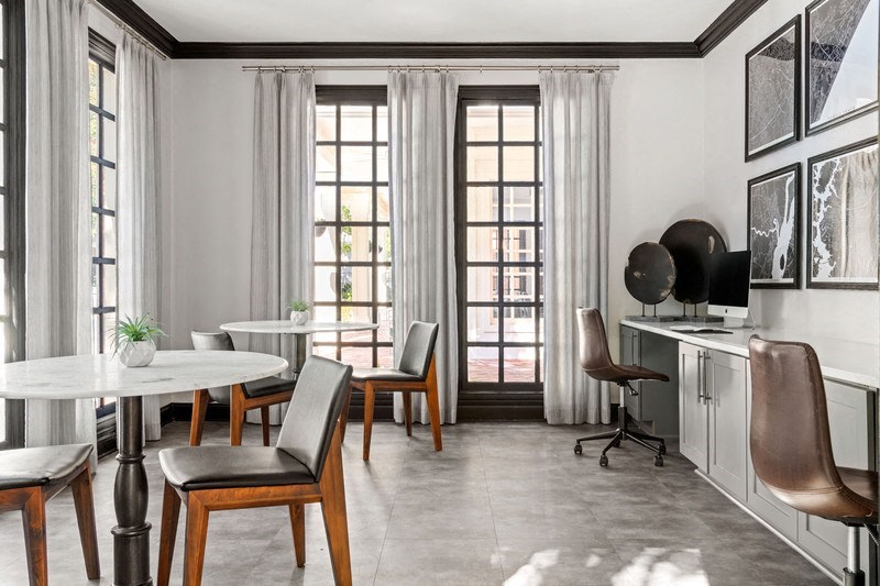 a room with a table and chairs and a television