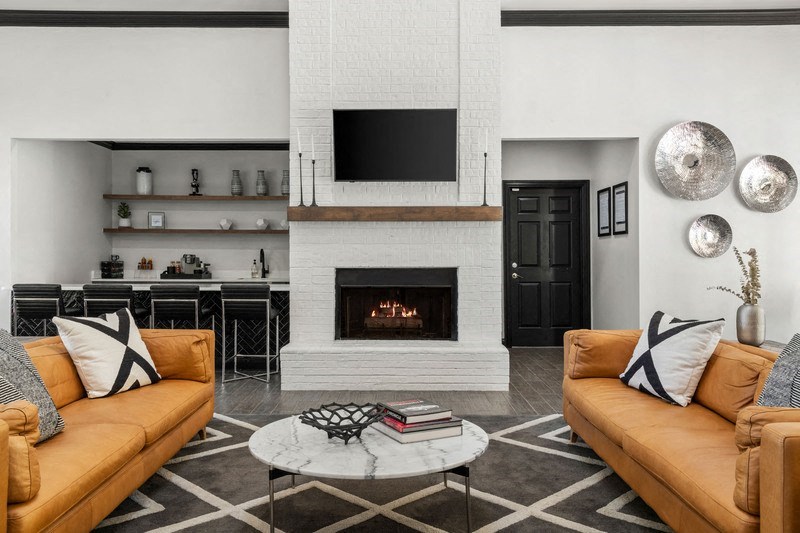 a living room with two couches and a coffee table in front of a fireplace