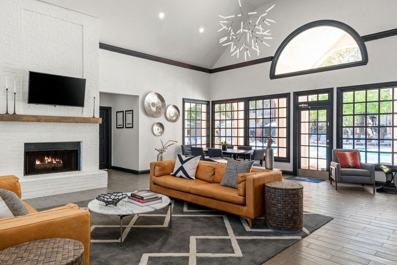 a living room with a fireplace and a tv on the wall