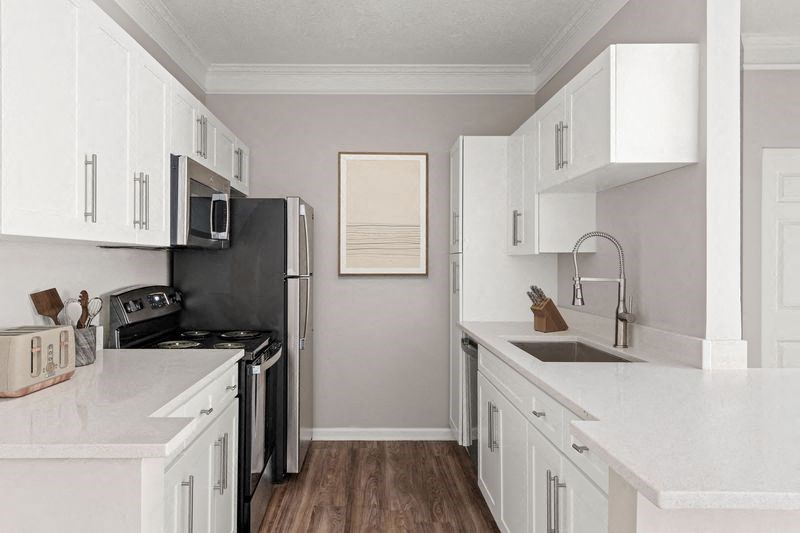 a kitchen with white cabinets and a black stove top oven