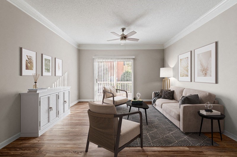 a living room with a large window and a ceiling fan