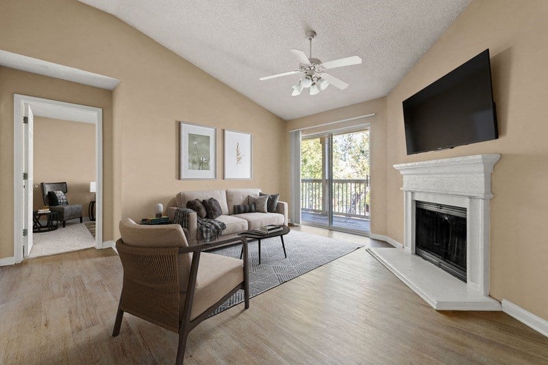 a living room with a fireplace and a tv