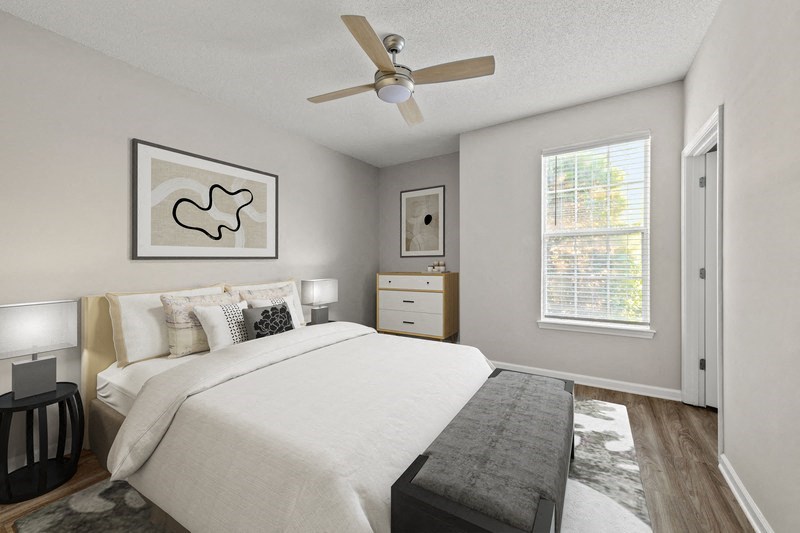 a bedroom with a large bed and a ceiling fan