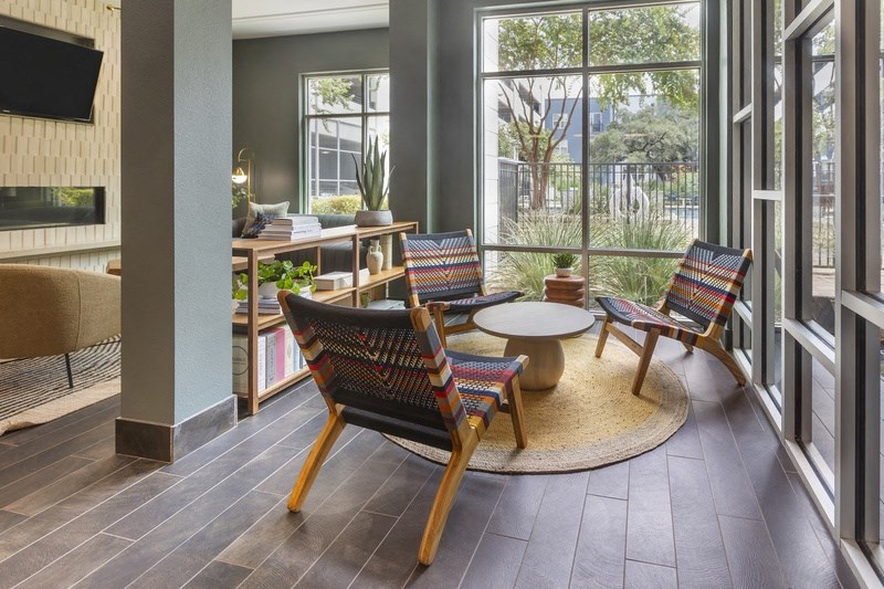 a living room with chairs and a table