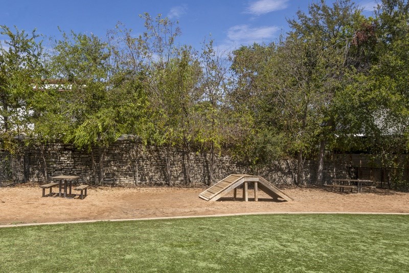 a seesaw in a park with a picnic table