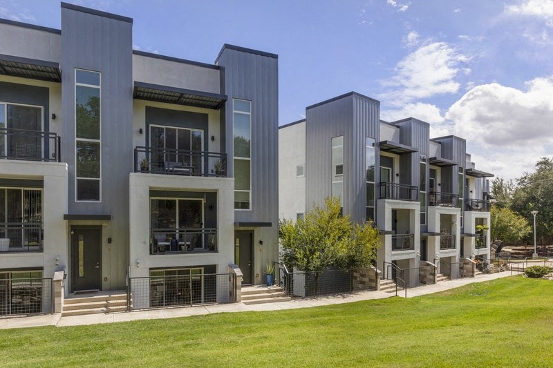 a row of houses with grass in front of them