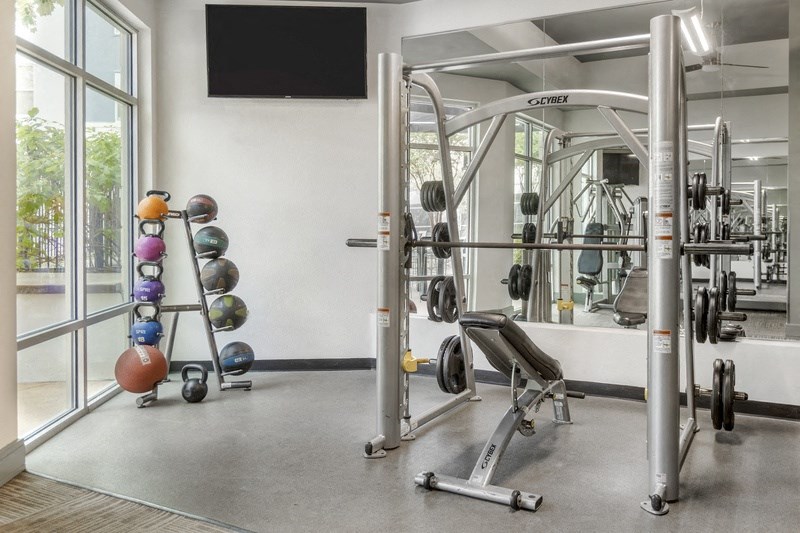 the gym with weights and cardio equipment at the belgard apartments