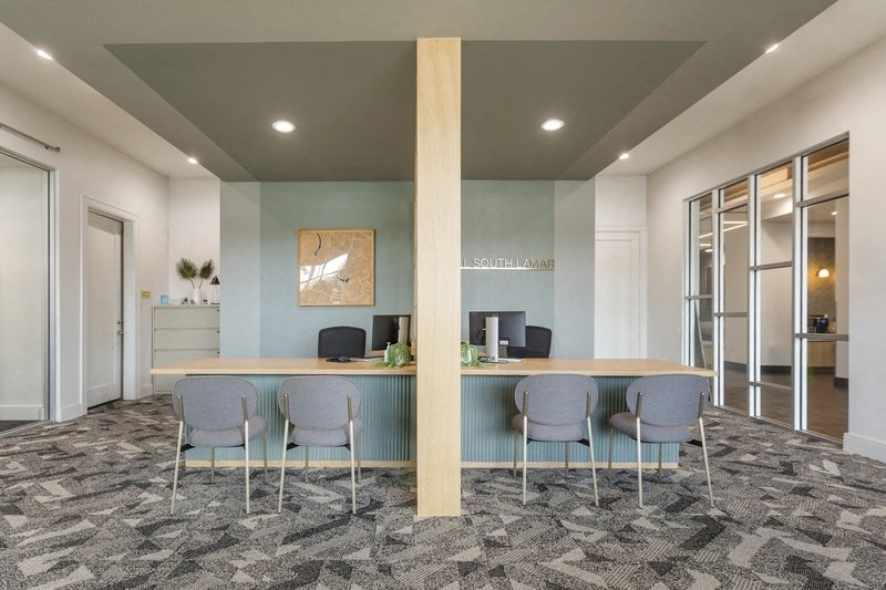 a conference room with a desk and chairs