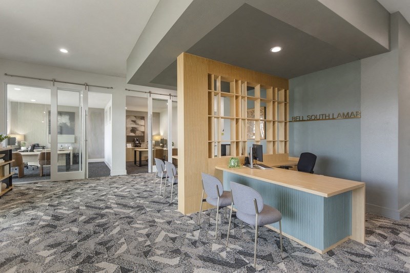a conference room with a desk and chairs