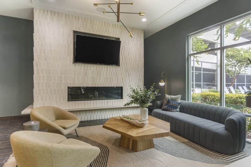 a living room with a couch and a coffee table and a fireplace