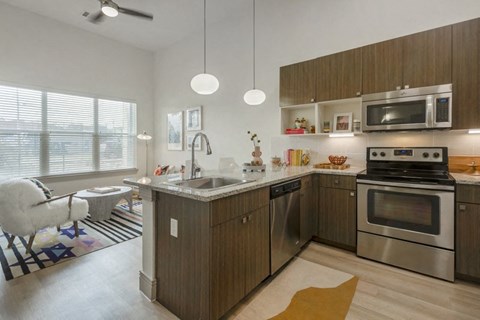 a modern kitchen with stainless steel appliances and wooden cabinets