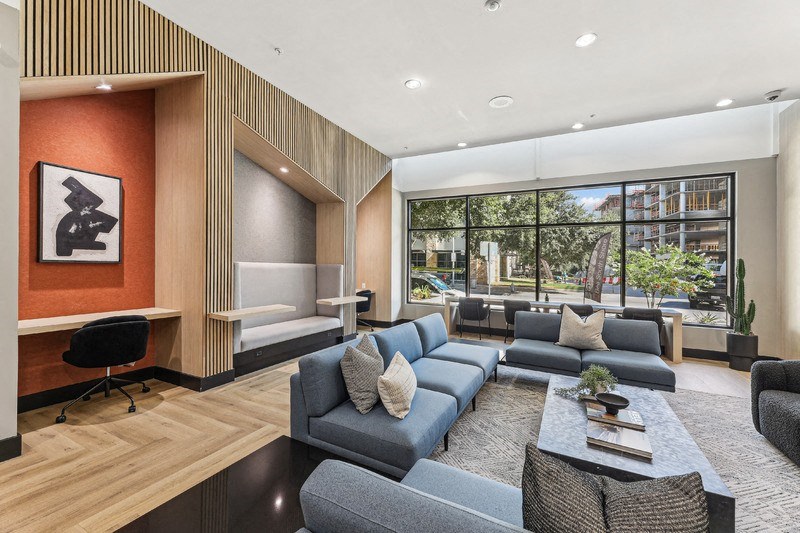 a living room with couches and a coffee table in front of a large window