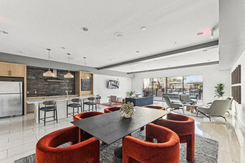 a living room and dining room with chairs and a table